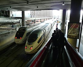 At Madrid Atocha, high-speed trains depart from a modern extension.